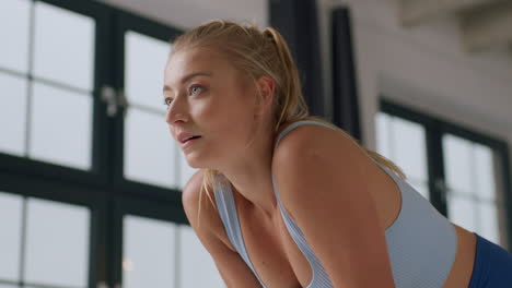 Young-athletic-woman-rests-during-exercise-proud-of-her-achievement