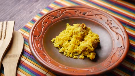 boiled yellow rice with meats on a plate