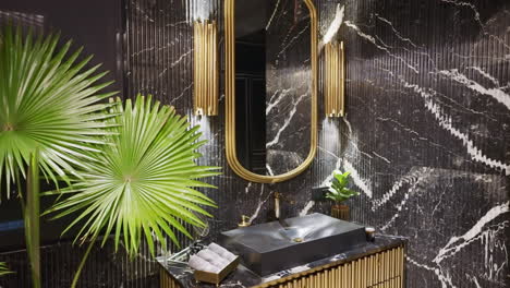 elegant mirror inside the modern bathroom with black marble panels. dolly down shot