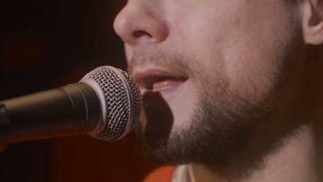 close up of man singing during a live music performance