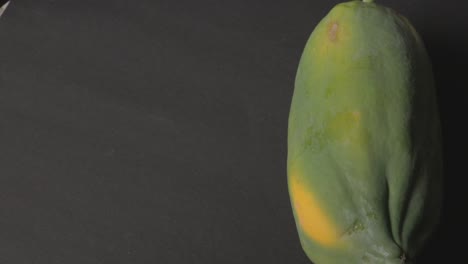 fresh papaya fruit isolated on black background