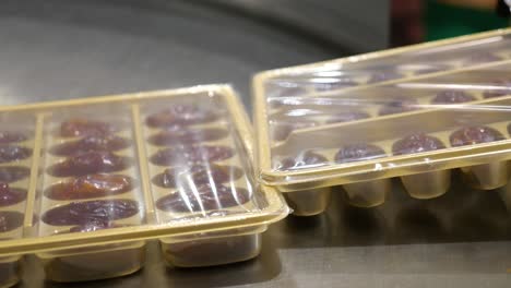 packaged fresh and best-quality dry dates are being collected for marking and tagging purposes through a machine