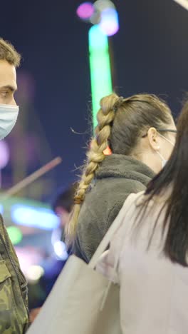 people wearing face masks at a night event