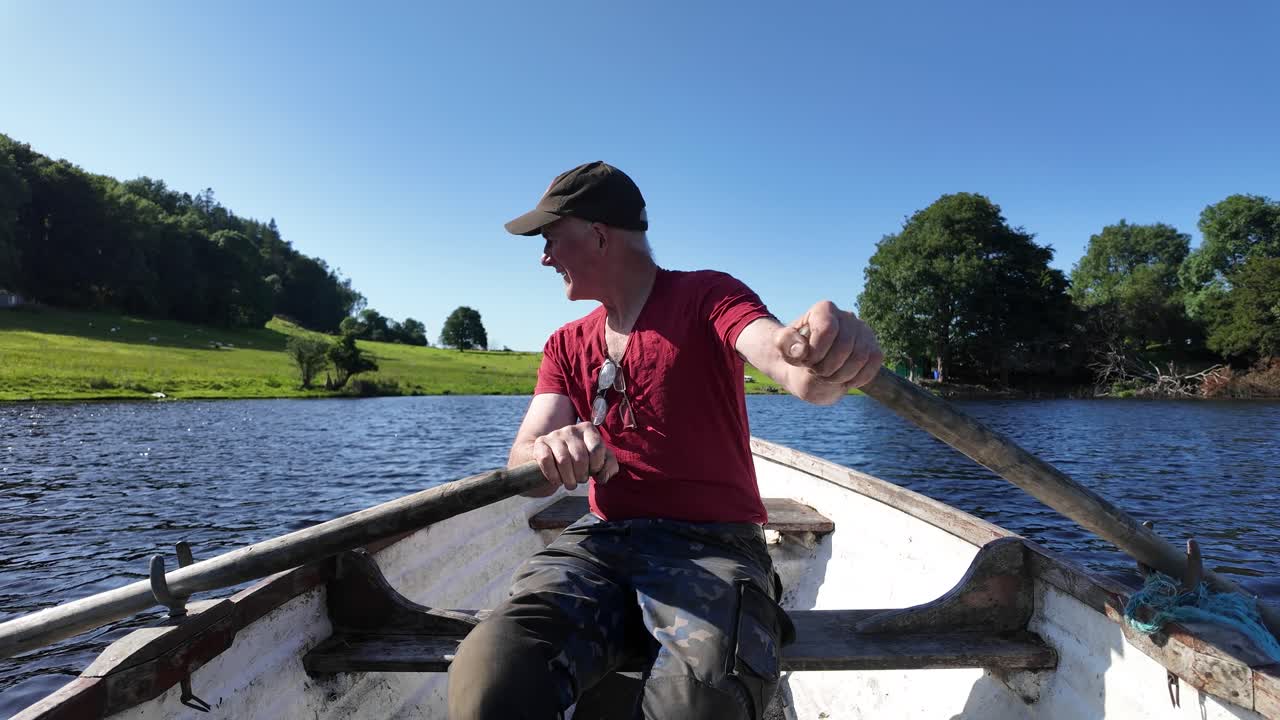 Happy Man Enjoying a Peaceful Day of Rowing on a Lake