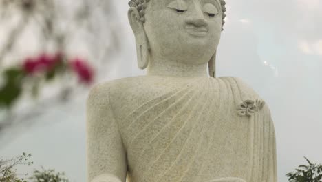 the big buddha phuket thailand cloudy day tilt shot with flowers