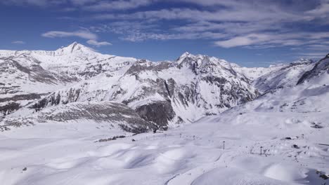 epic footage of mountain range covered in snow with ski chairlifts - dolly in shot - shot in tignes and val d'isere