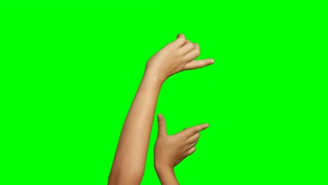 person making hand gesture against green screen background