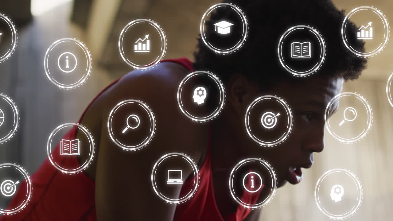 Animation of multiple icons over tired african american male athlete wiping sweat
