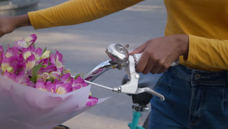 woman riding a bicycle with flowers