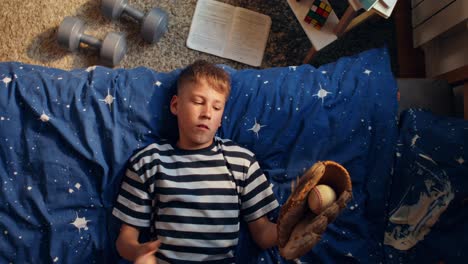 boy playing baseball in his bedroom
