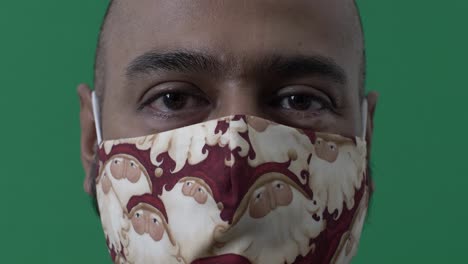 Adult-Male-Wearing-Santa-Claus-Face-Mask-Looking-At-Camera