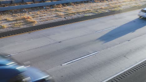 fast driving vehicles on multi lane highway in california on sunny day