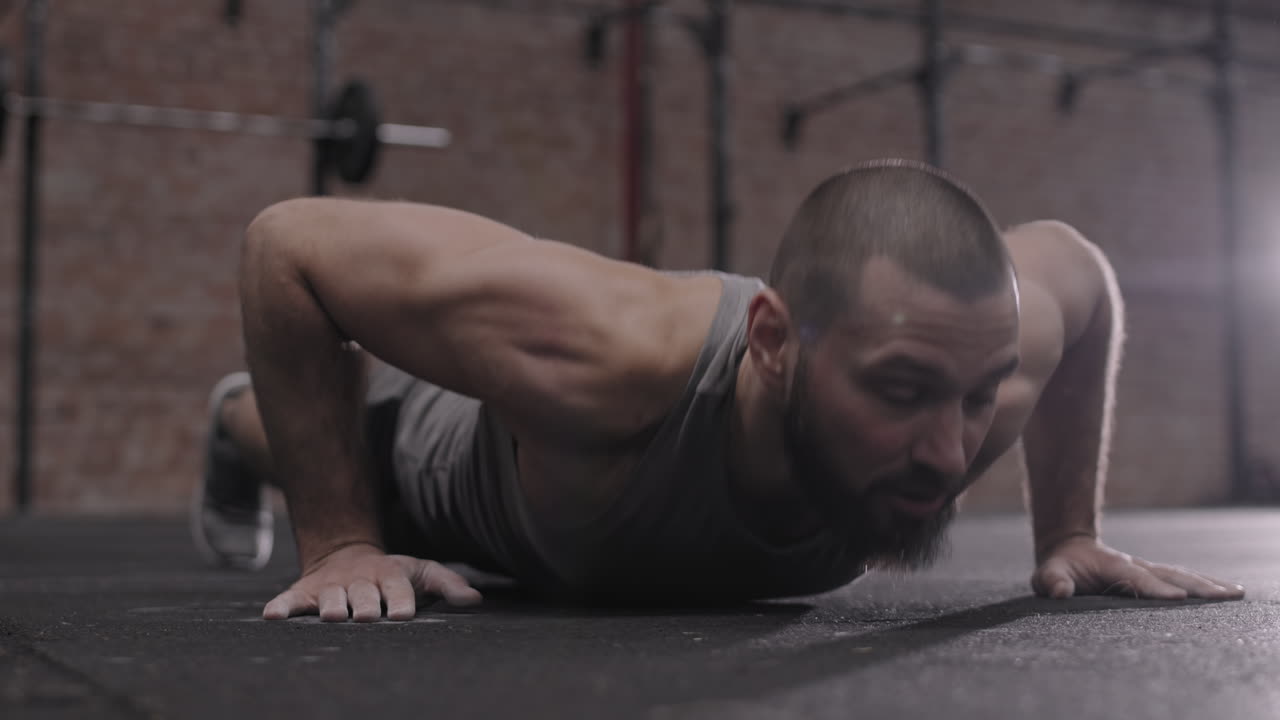Athletic Man Doing Push Ups in Gym