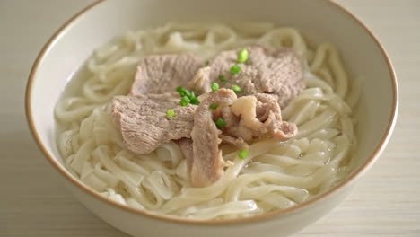 homemade udon ramen noodles with pork in clear soup