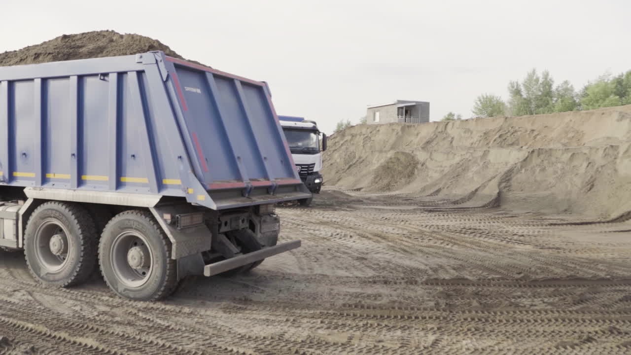 Dump Trucks Loading Sand at Construction Site