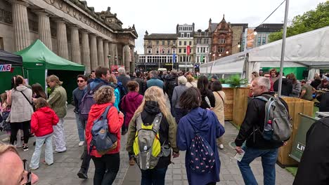 people walking through a busy street market