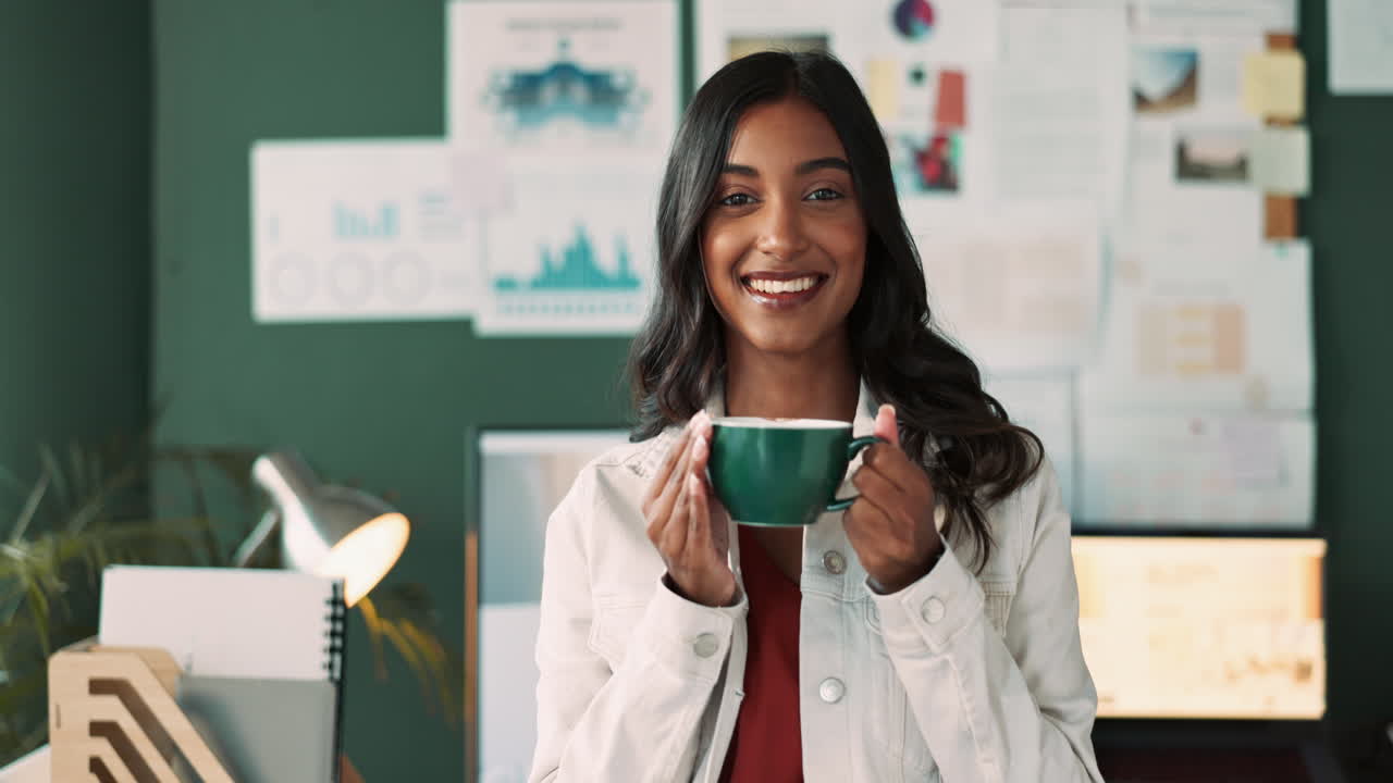 Portrait of a smiling woman in an office holding a cup