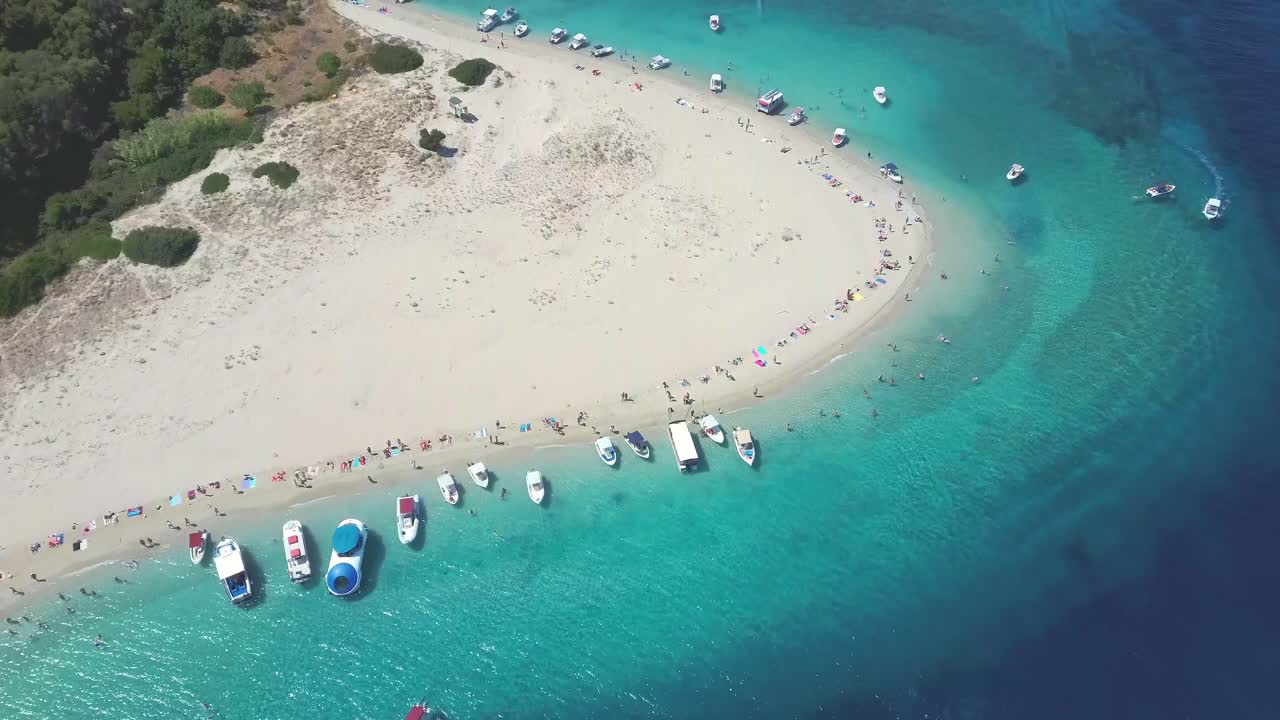 Aerial drone view of iconic small uninhabited island of Marathonisi featuring clear water, sandy shore and natural hatchery of Caretta-Caretta sea turtles, Zakynthos, Greece