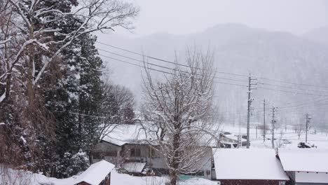 snow falling in slow motion over winter landscape in hida japan