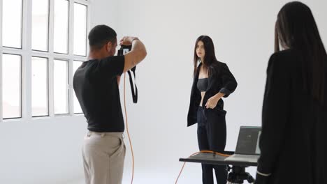 fashion photoshoot with model and photographer in studio