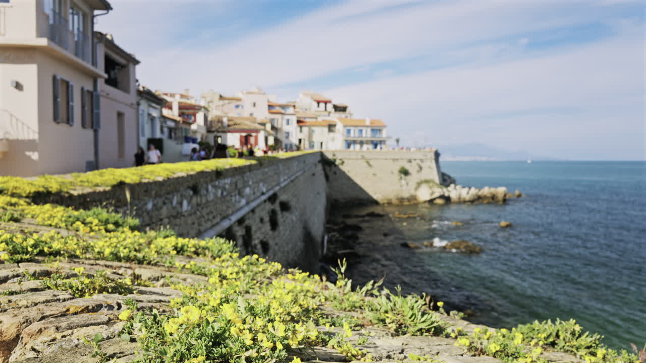 Blurred view of people walking on the coast of Antibes, France