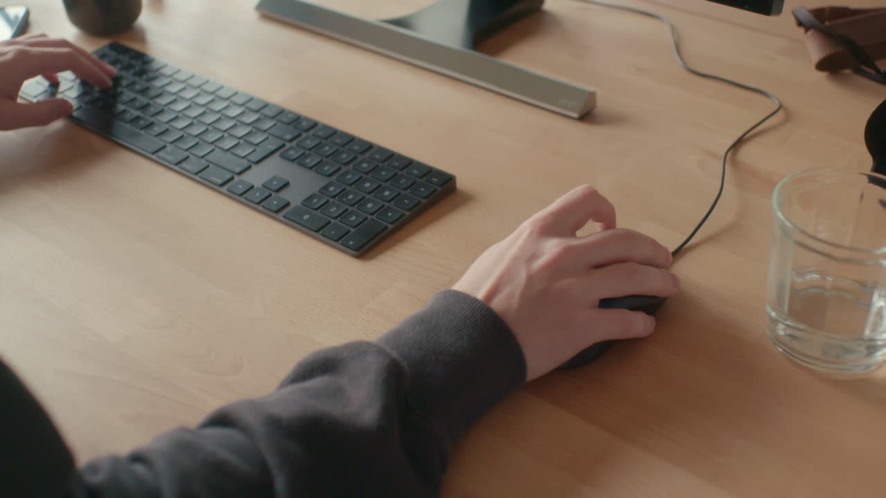 Man working in office and clicking with the computer mouse