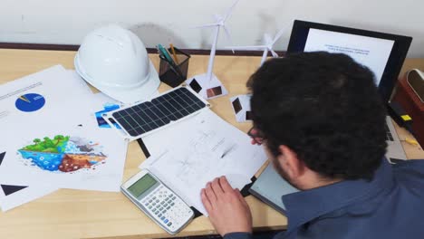 overworked engineer sleeping on his desk after a long day