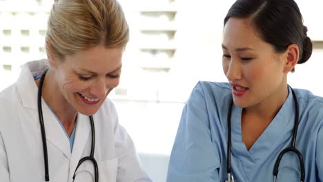 doctor and nurse reading over a file