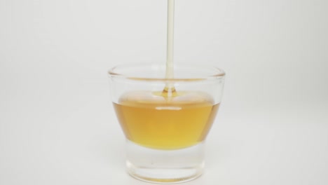 close up, pour the honey into a small glass.