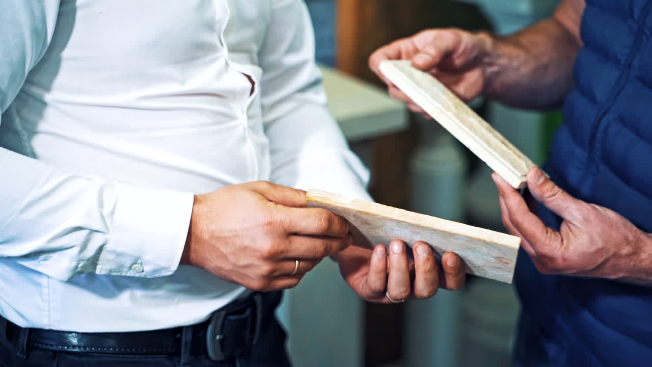 Customer checking marble stone. Close up of man advising customer on the purchase of marble
