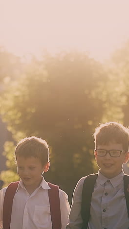pretty lady in long red dress walks with schoolchildren throwing away books and sheets at back sunlight slow motion