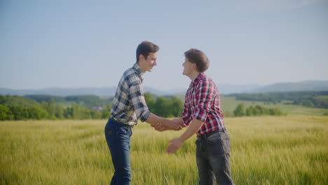 two farmers shaking hands in a wheat field