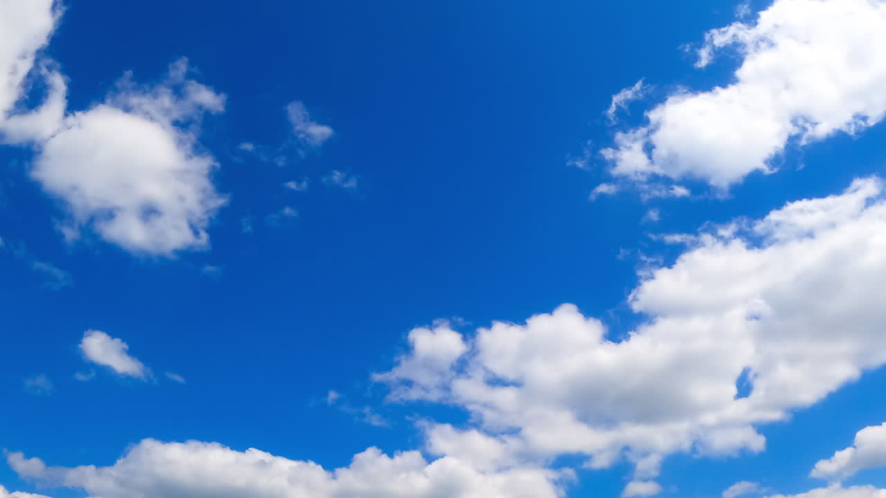 Timelapse of moving clouds. Clouds transform over a vibrant blue sky, showcasing movement and texture throughout the day