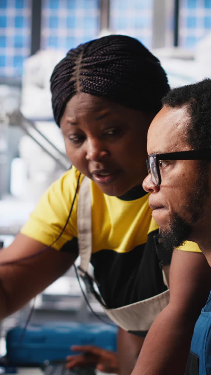 Vertical Video Black engineers collaborate on photovoltaic system designs at computers