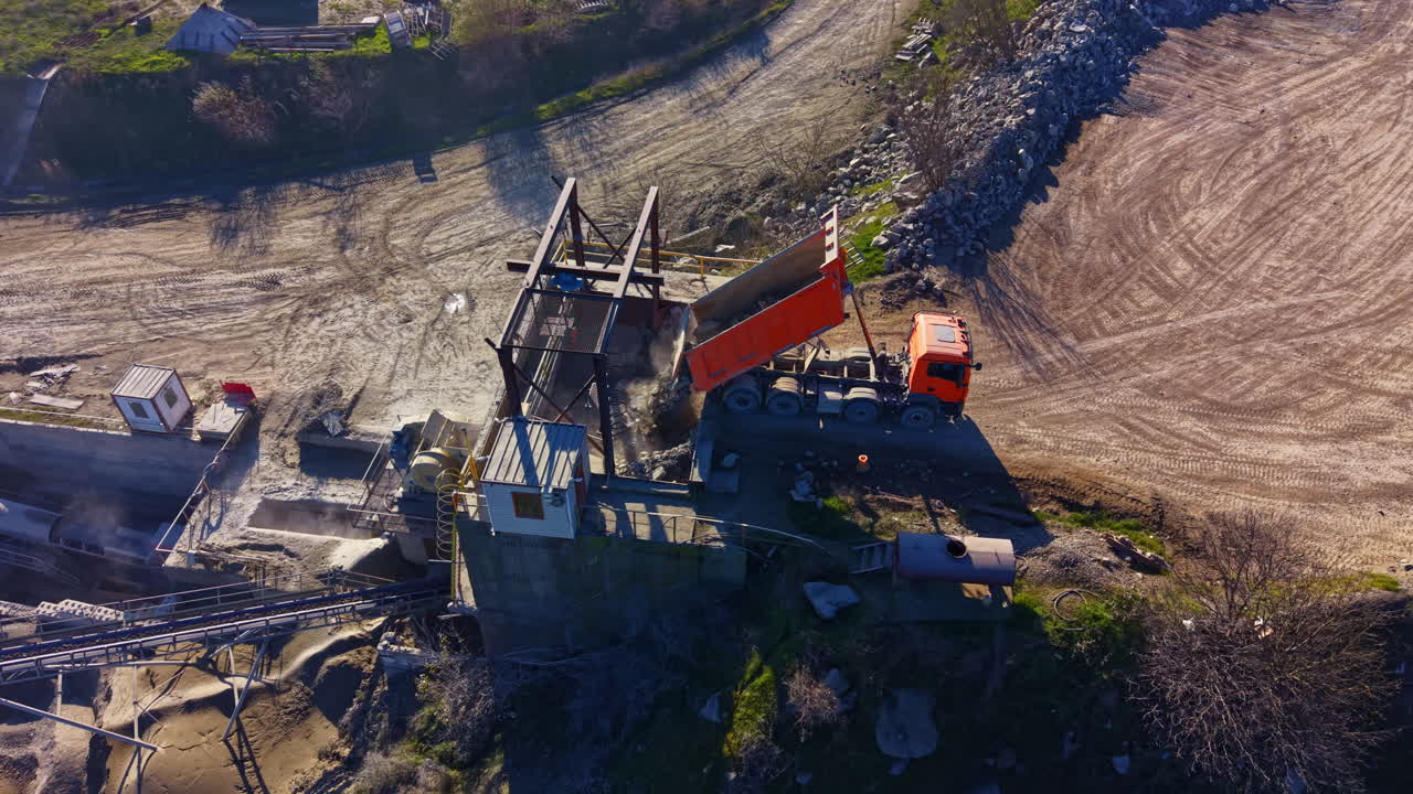 Construction progresses at a gravel pit site with heavy machinery and natural textures in a remote location