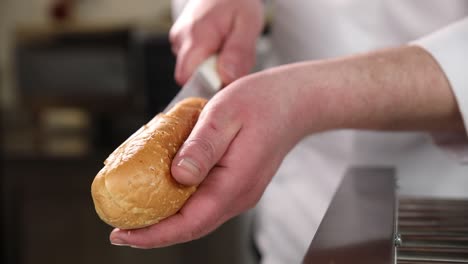 chef preparing a hot dog bun