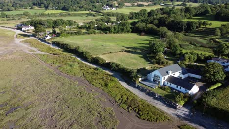 Aerial-view-Traeth-Coch-Pentraeth-farmland-countryside-with-vacation-cottages-along-salt-marsh