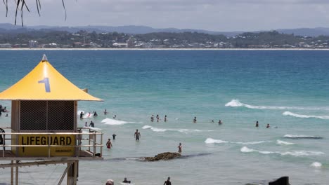 lifeguard tower overseeing beachgoers in the ocean