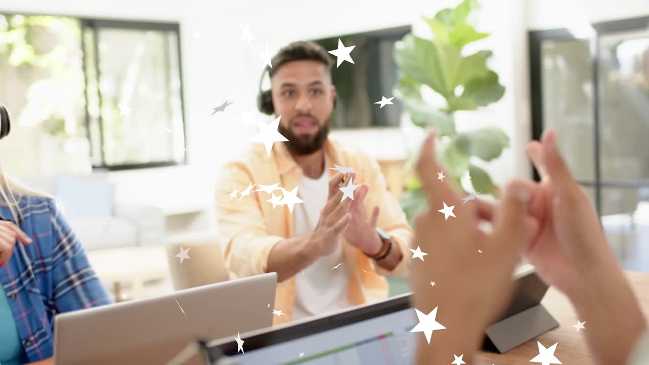 Pair responding to offscreen prompt, recording podcast, gesturing near laptop mic with star overlay