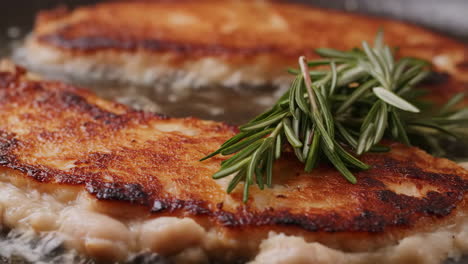 adding rosemary to crispy fried food in a pan