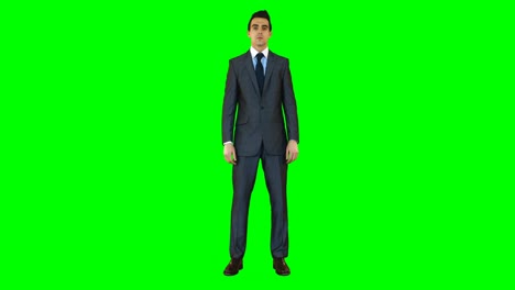 businessman standing against green background