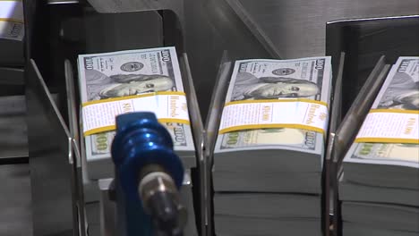 stack of 100 dollar bills at the printing press