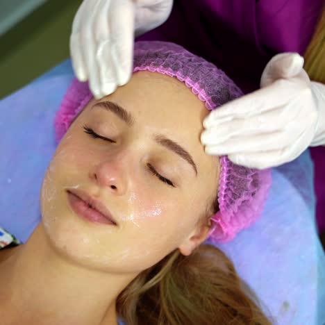 woman receiving a relaxing facial skincare treatment
