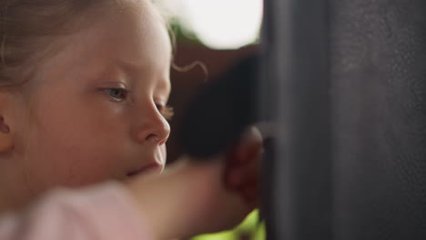 Cute-little-child-plays-game-touching-tablet-computer-screen