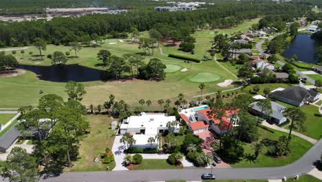 golf course in affluent neighborhood in panama city, florida. aerial panning shot