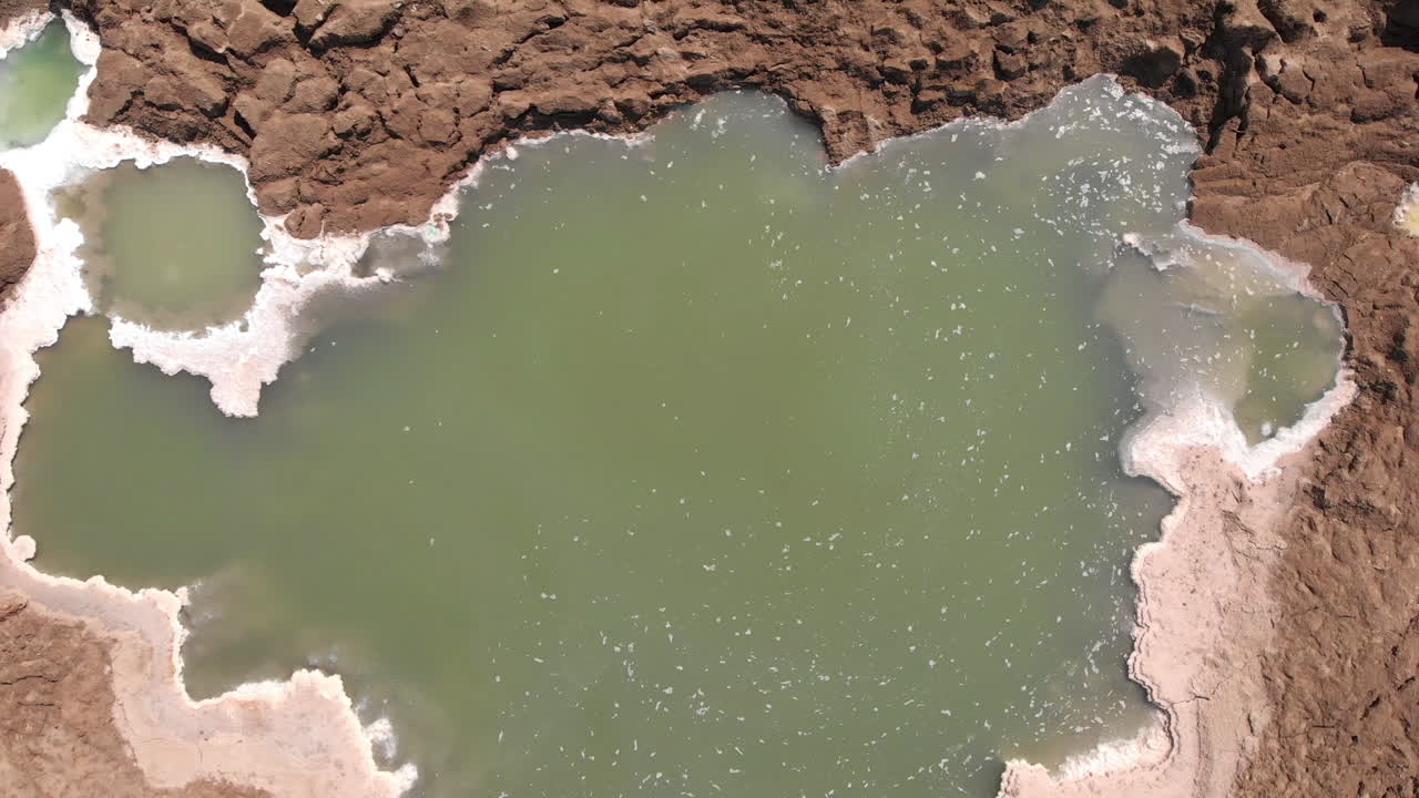 Drone flying over sinkholes in dead sea