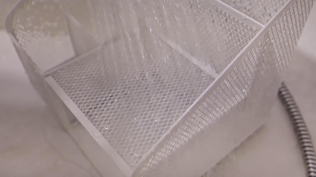 Flowing water washes over desk organizer reflecting fragility of control