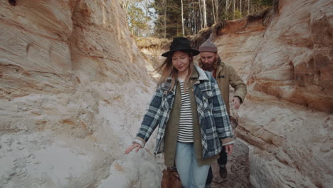 couple and dog walking through canyon