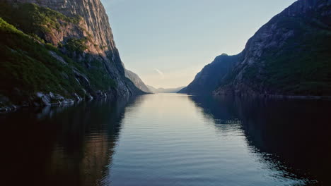 dolly shot, pushing in low and slow over a fjord in norway