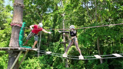couple ziplining through forest